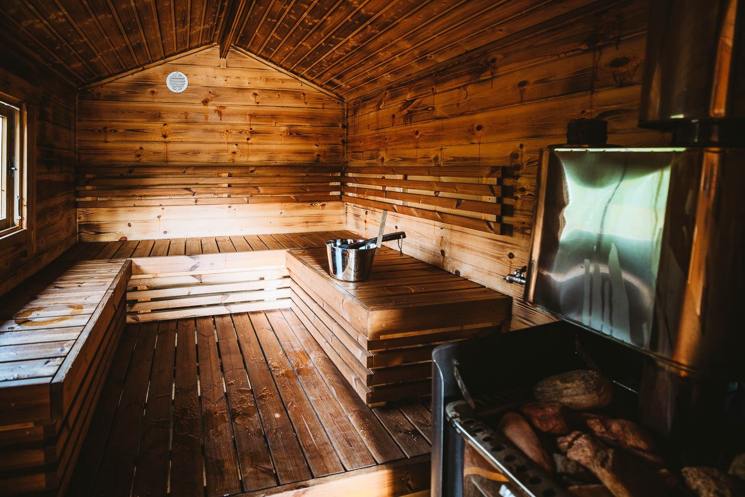 Warm wooden interior of a lakeside sauna