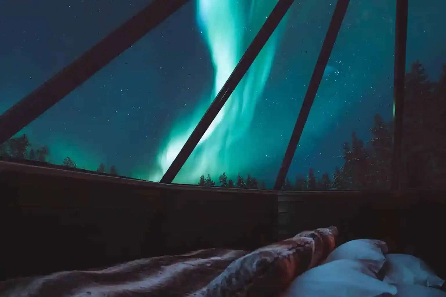 Northern Lights seen from the bed of an Aurora Cabin