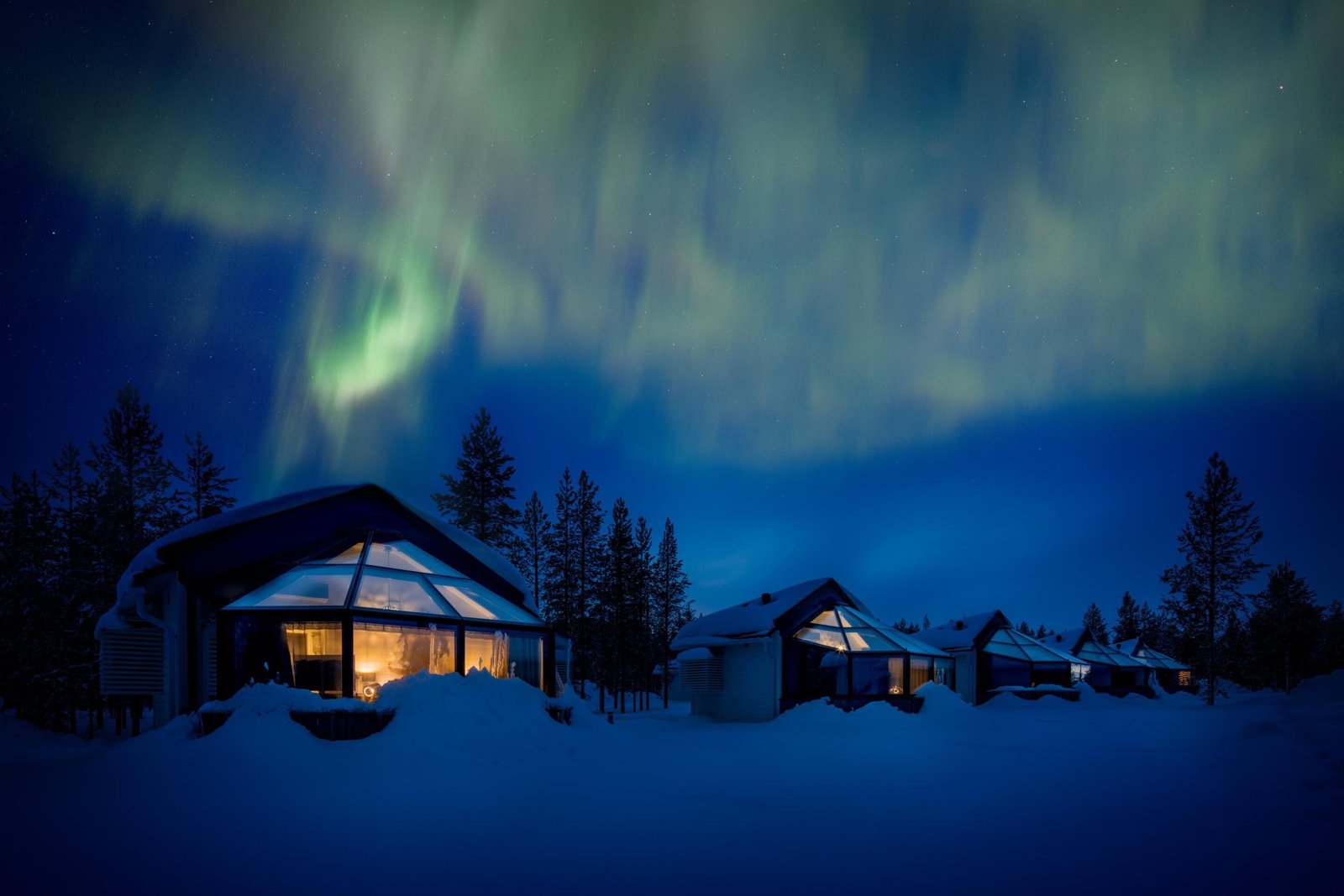 Glass igloos under the Northern Lights at Santa Claus Village