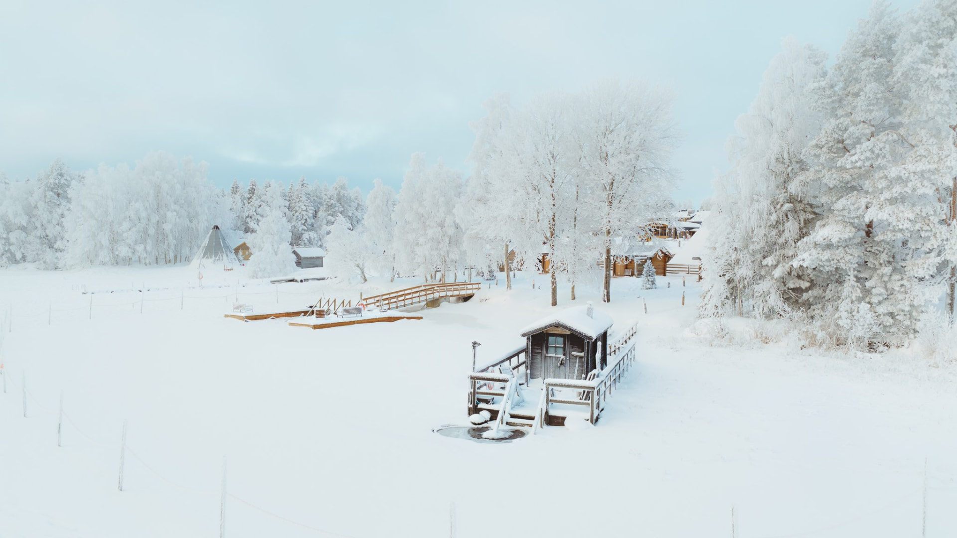 Aerial view of a snow-covered lakeside in Rovaniemi
