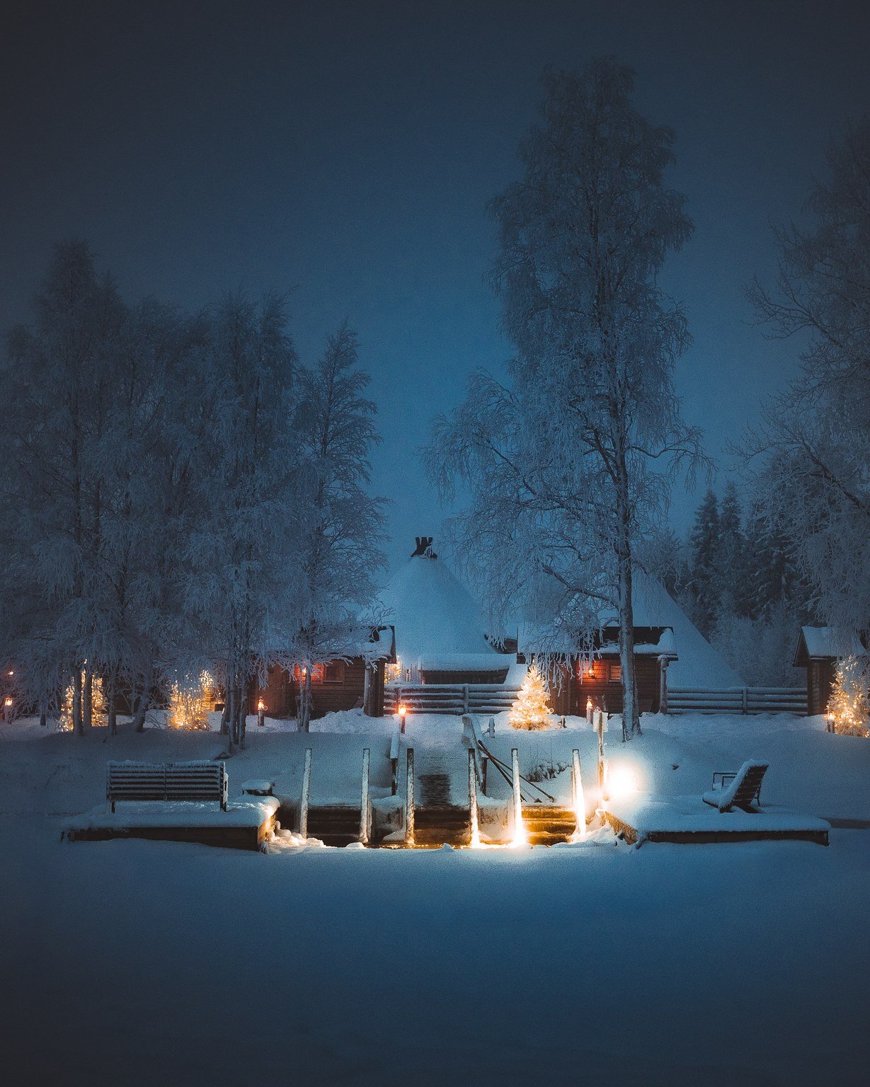 Lakeside sauna glowing on a winter night