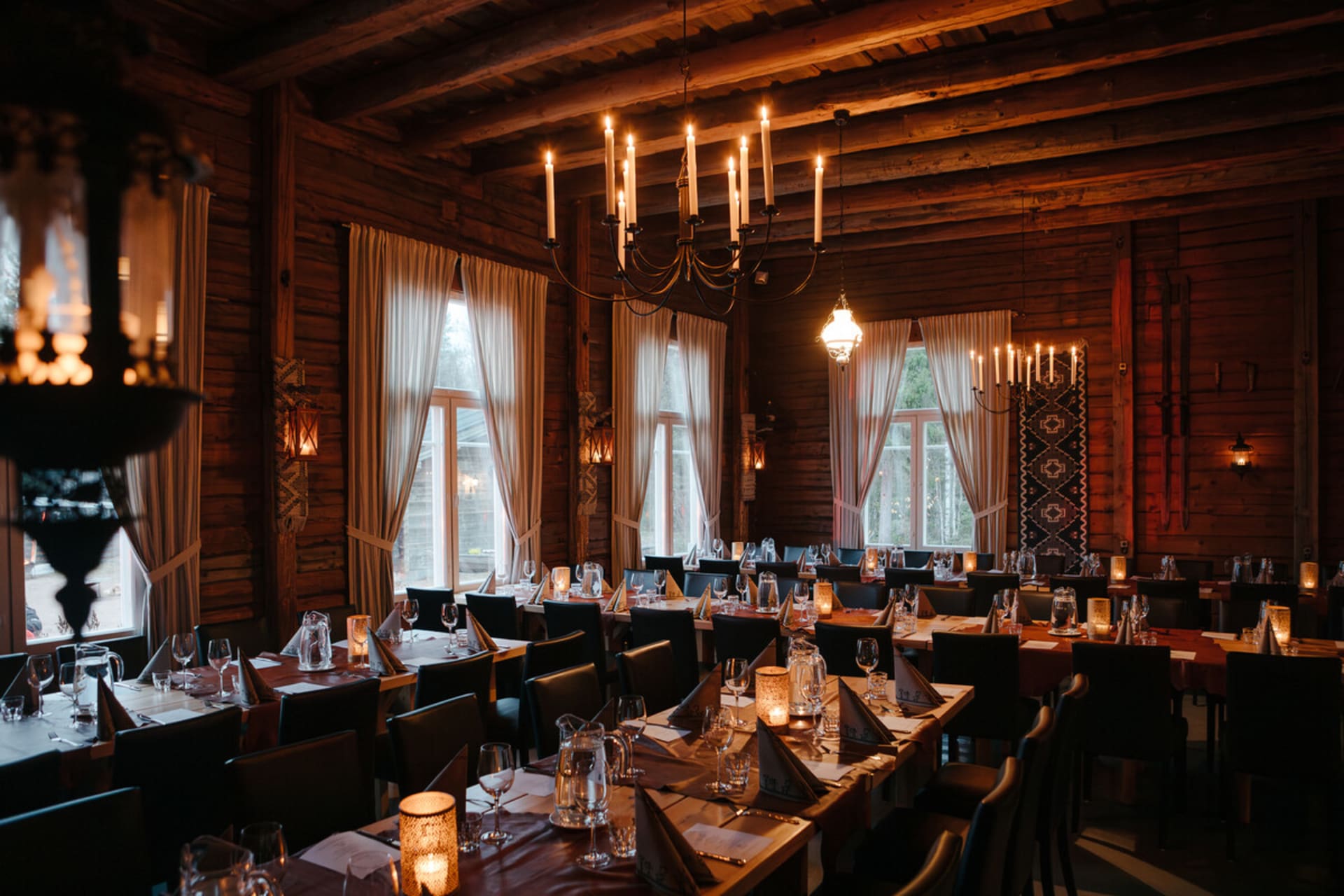 Poropirtti dining hall set for a dinner